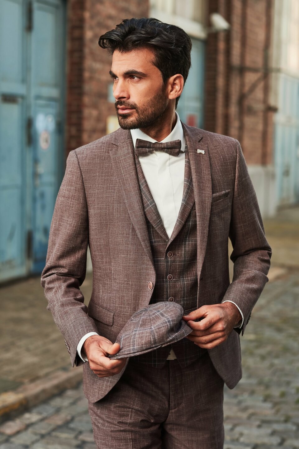 een afbeelding van een man in een pak en vlinderdas