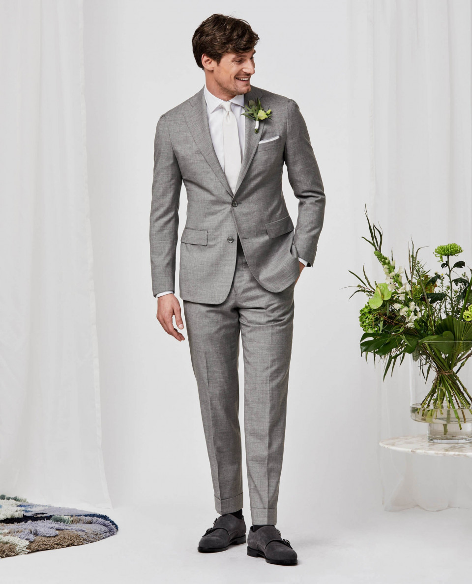 een man in een grijs pak en wit overhemd