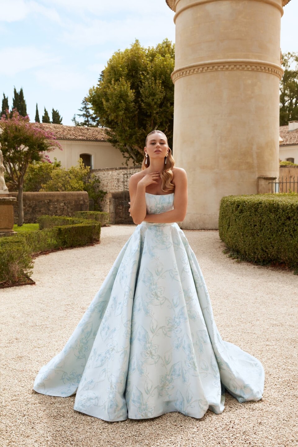 een vrouw in een blauwe jurk poseert voor een foto