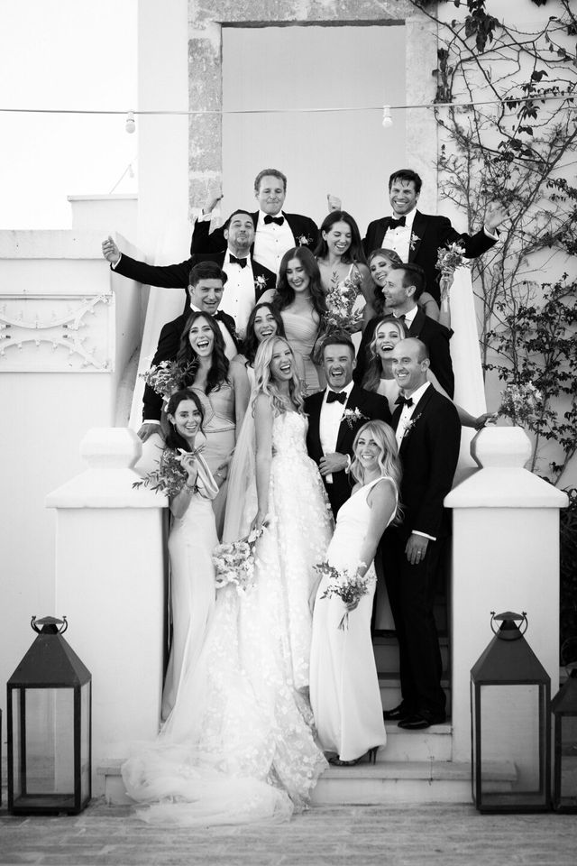 A black and white detail of the bride embracing the groom.