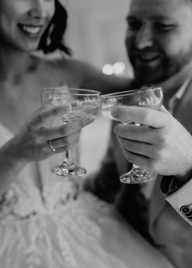 Brautpaar stößt mit Champagner Gläsern an