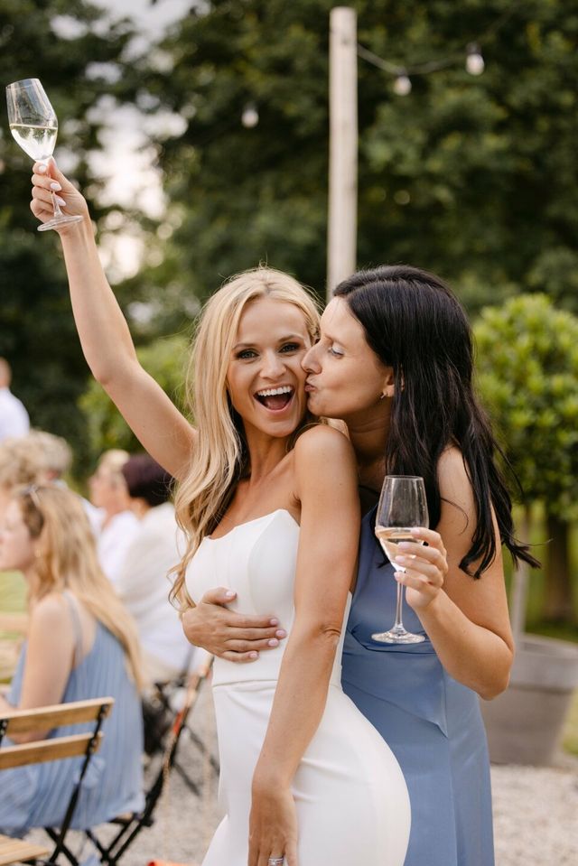 Wedding guests in semi-formal dresses at an outdoor reception