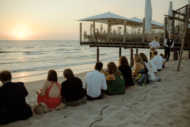 gasten zitten op strand