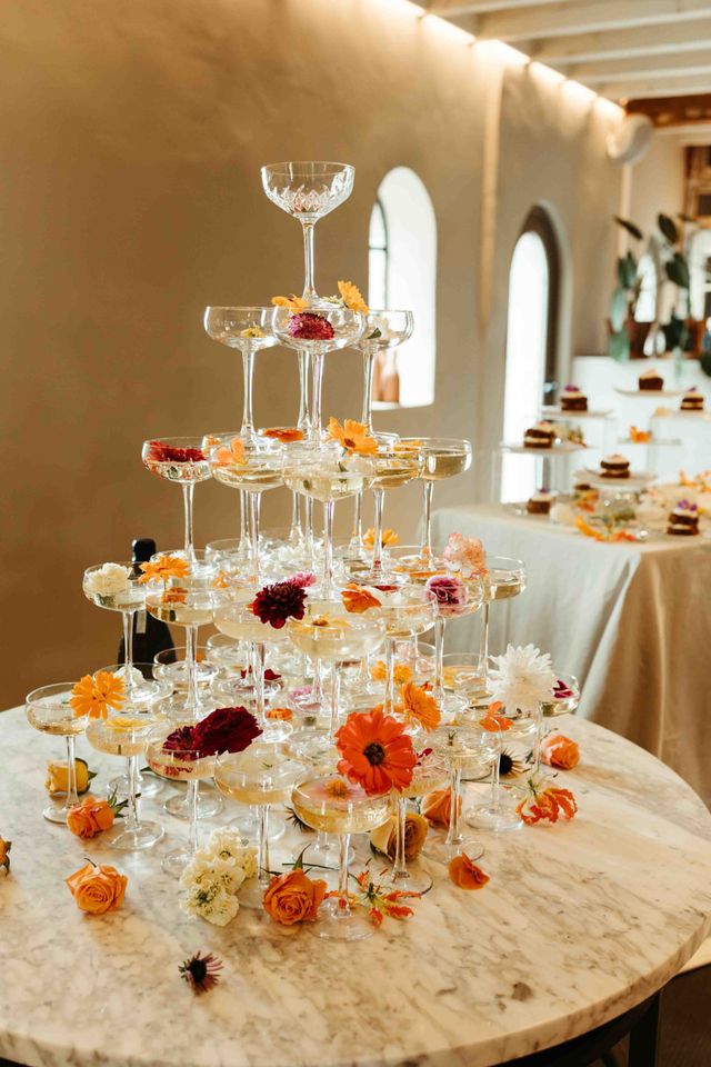 Floral champagne tower with colorful blooms between the glasses