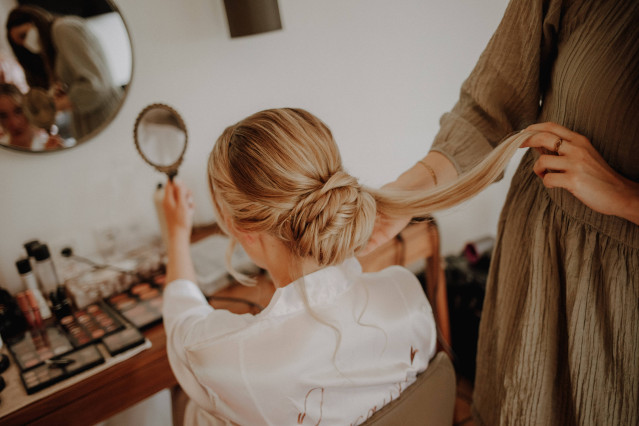Braut bekommt Haare von Visagistin hochgesteckt