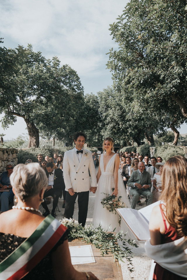 The couple walks hand in hand back up the aisle just after the ceremony.