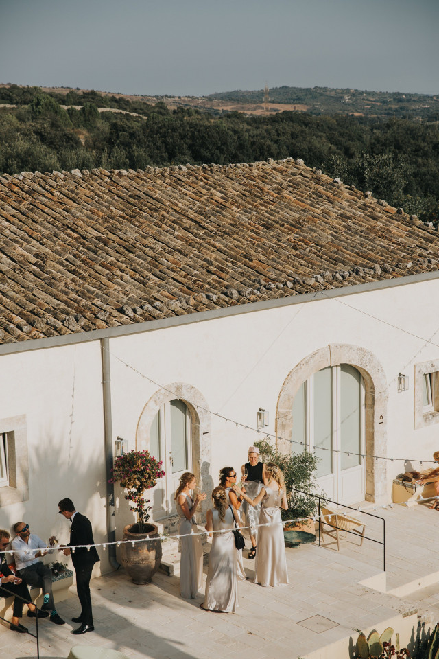An aerial view of a Mediterranean manor with tiled roofs.