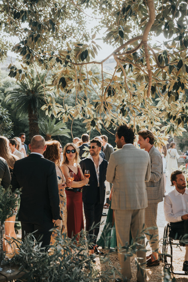 Guests mingling at a wedding reception in cocktail outfits