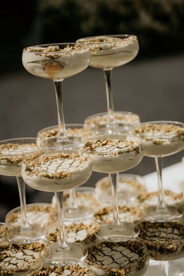 Champagne tower with coupe glasses rimmed in gold crumble