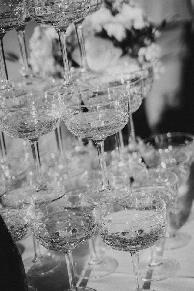 Close-up of a stacked champagne coupe tower in black and white