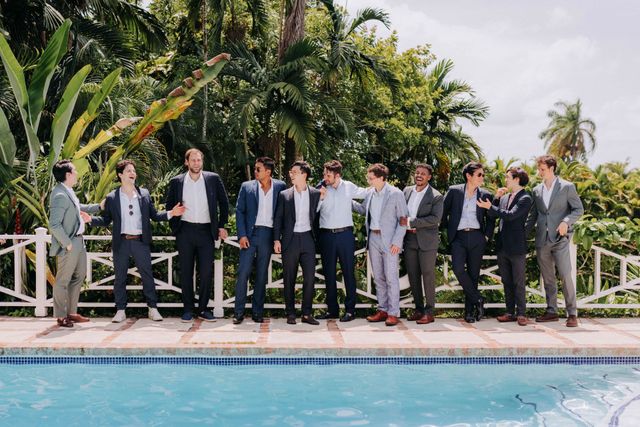 Men in relaxed dressy casual suits at an outdoor wedding