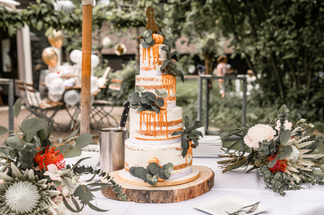 Semi-naked wedding cake with drip and eucalyptus