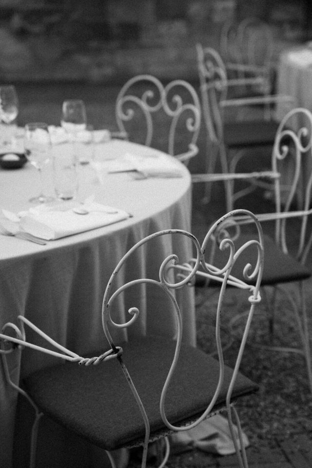 A black and white detail of an elegantly set table with fine styling.