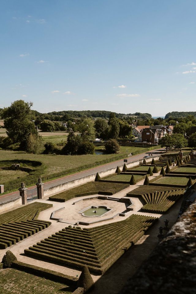An aerial view of an expansive formal garden with symmetrical hedges at a venue.