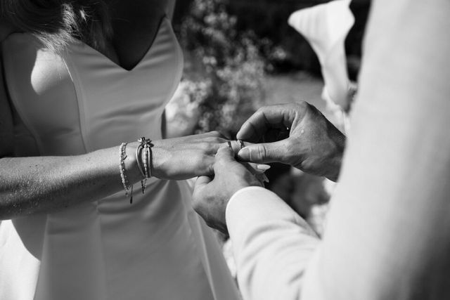 Close-up of a wedding ring being placed on a finger during the ceremony