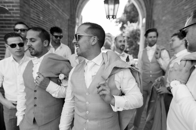 Groom and groomsmen in semi-formal suits and waistcoats