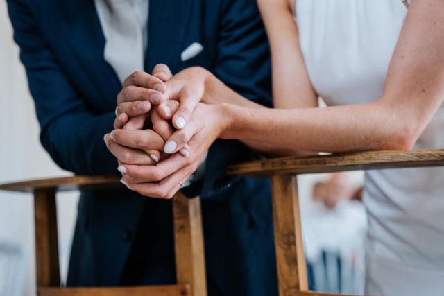 A detail of the couple's intertwined hands during the ceremony.