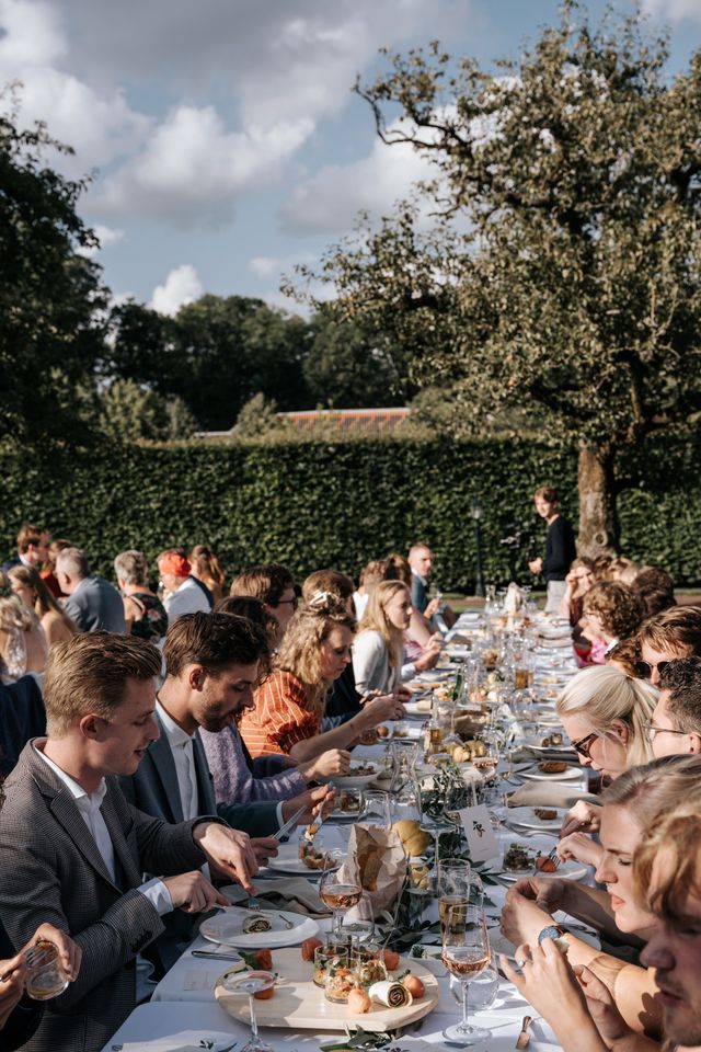 Guests sit at a long, festively set table during the celebration.