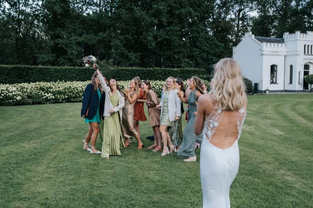 Bride tossing her bouquet at a celebration