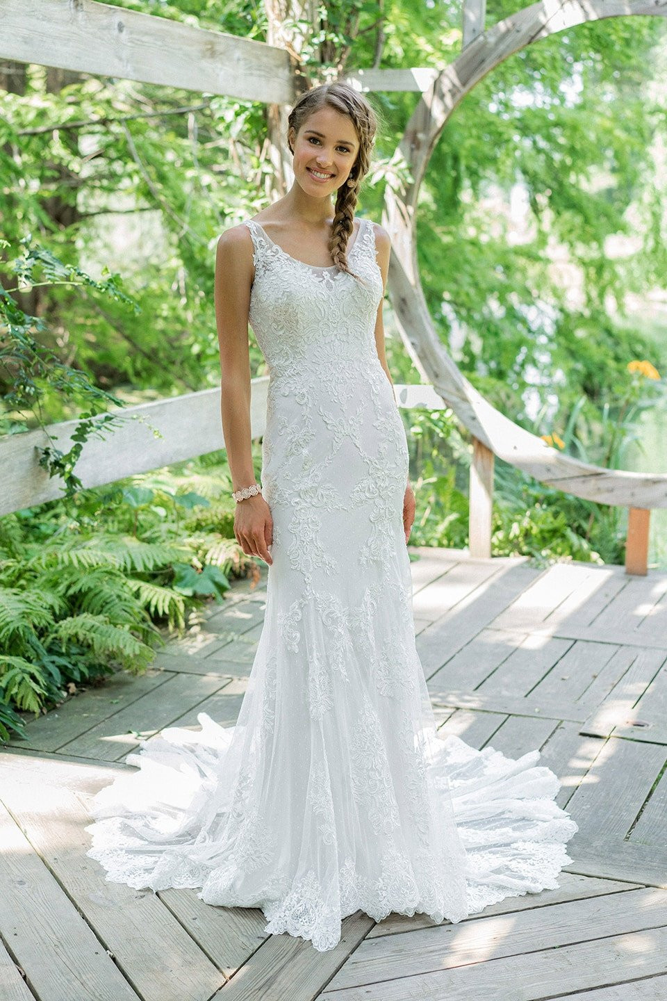 een bruid in een bruidsjurk die op een houten dek staat