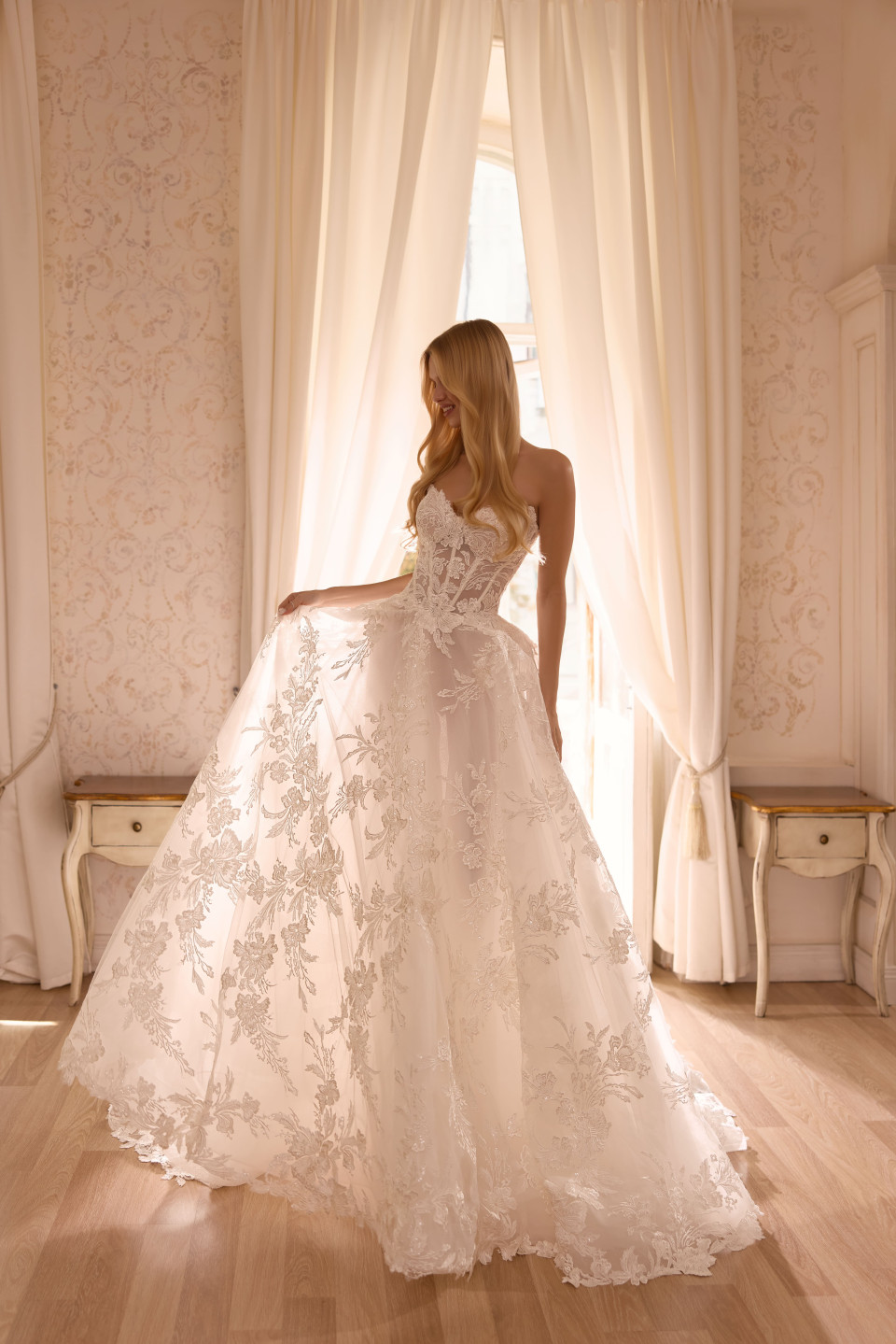 een vrouw in een trouwjurk die voor een raam staat