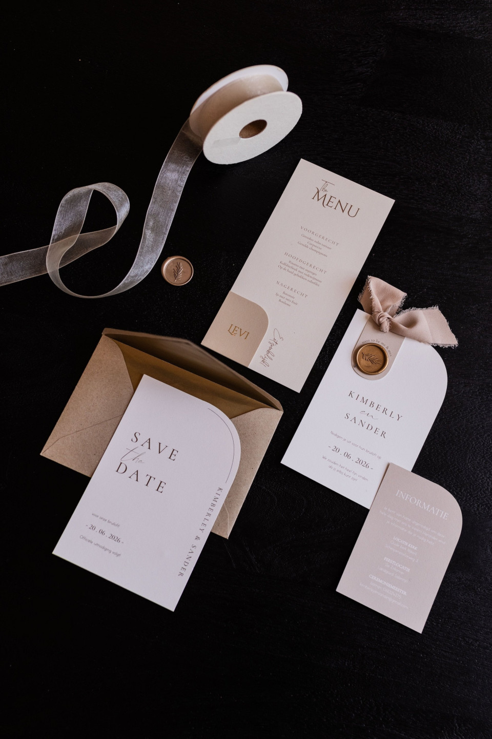 de trouwstationery en save-the-date kaarten uitgestald op de tafel