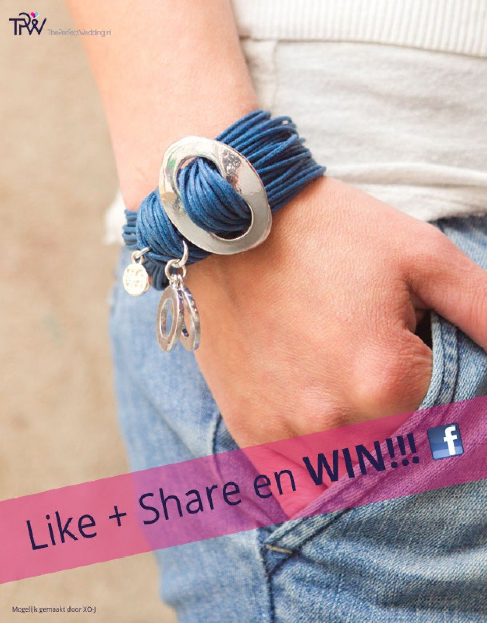 een vrouw die een blauwe armband met een zilveren bedel draagt