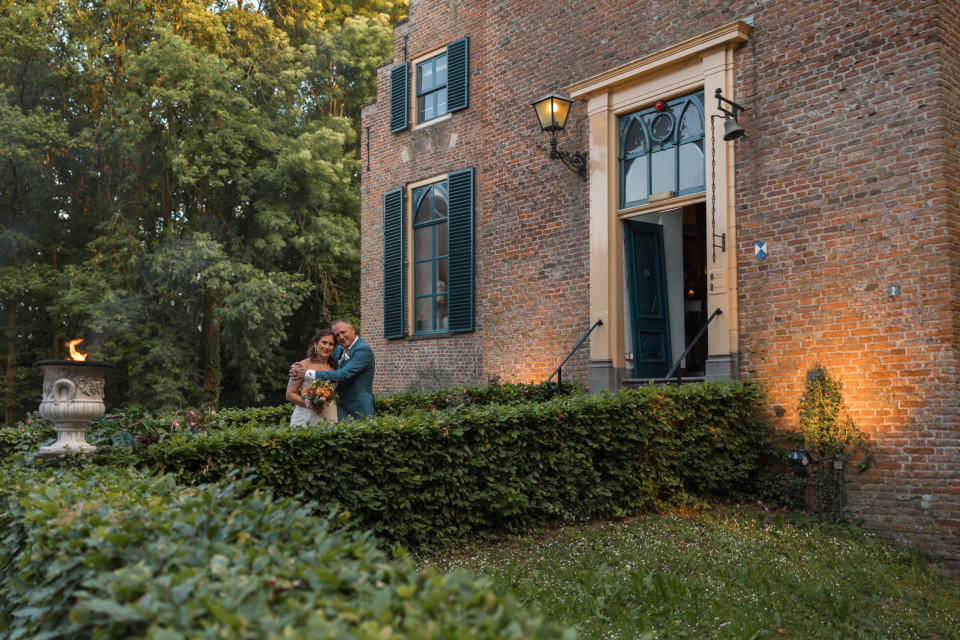 een stel staat voor een bakstenen huis
