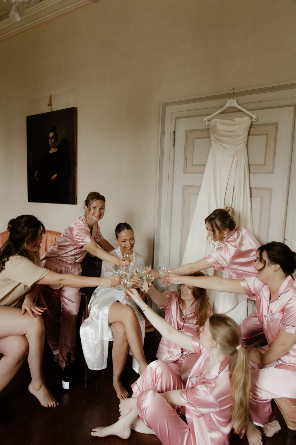 een grote groep mensen in het roze die in een kamer zitten