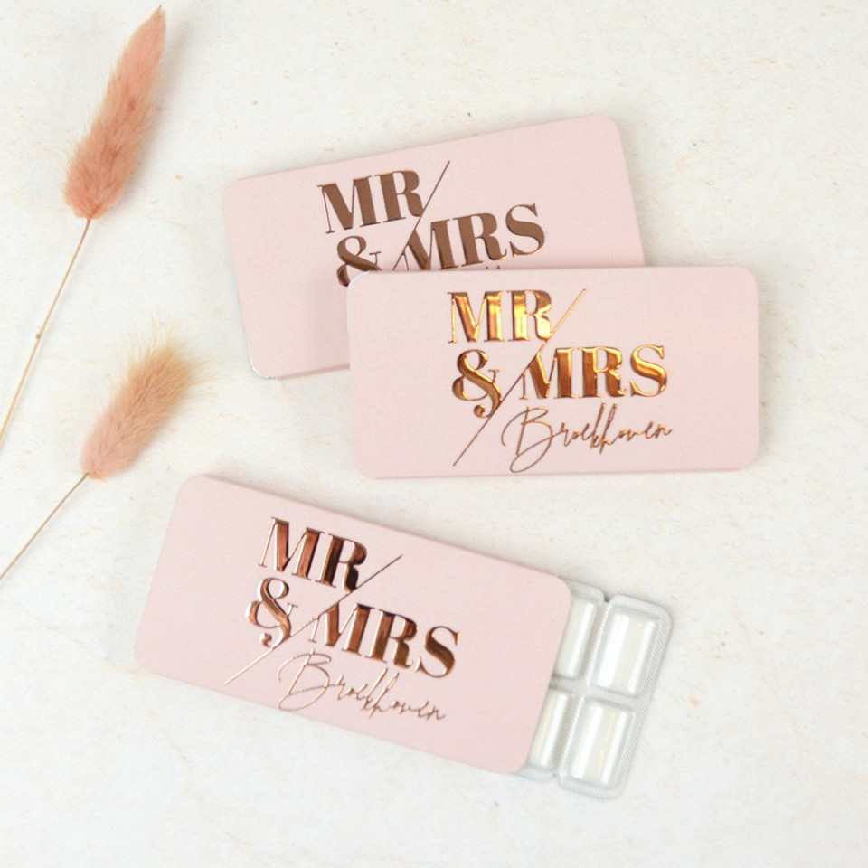 twee roze en gouden bruiloftspillendoosjes met de woorden mr en mrs