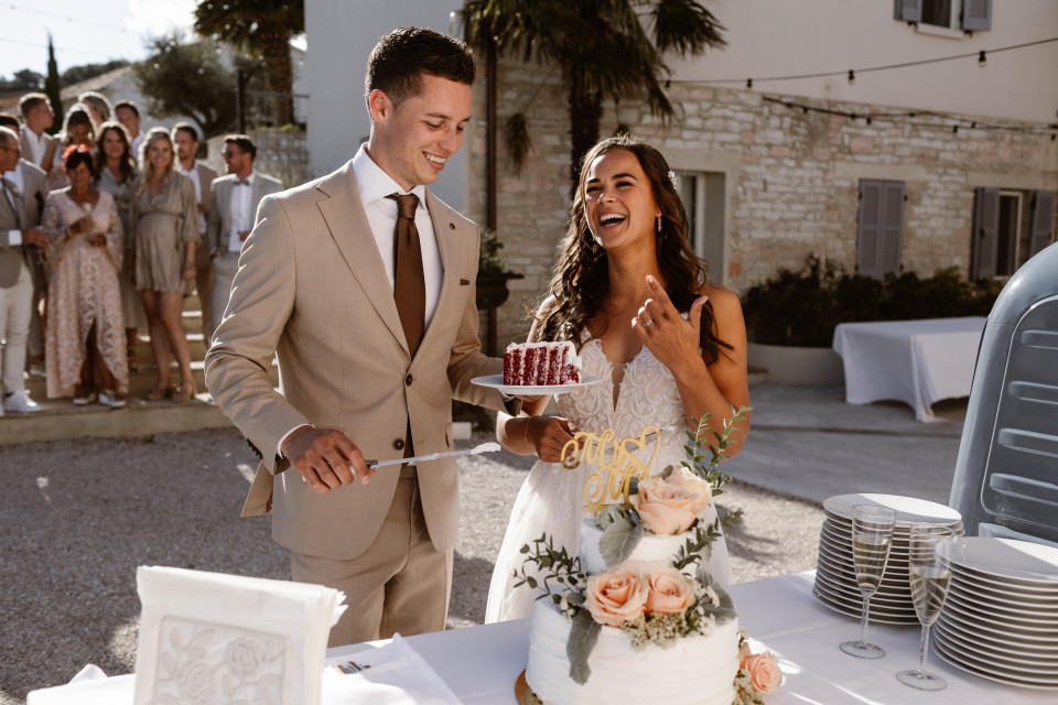 een bruidspaar snijdt hun trouwtaart aan