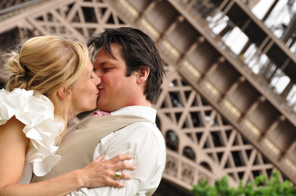 een man en vrouw die kussen voor de Eiffeltoren