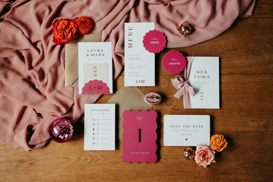 de trouwuitnodigingen en save the date-kaarten op de tafel