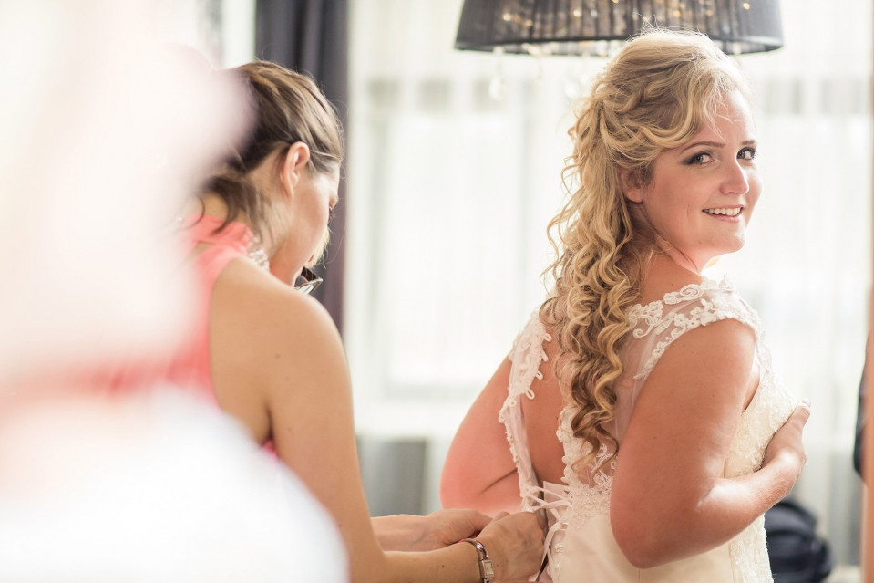 een vrouw in een trouwjurk maakt zich klaar om zich klaar te maken