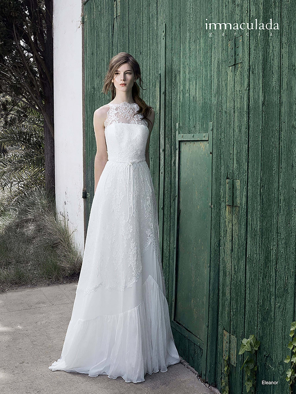 een vrouw in een witte trouwjurk die voor een groene deur staat