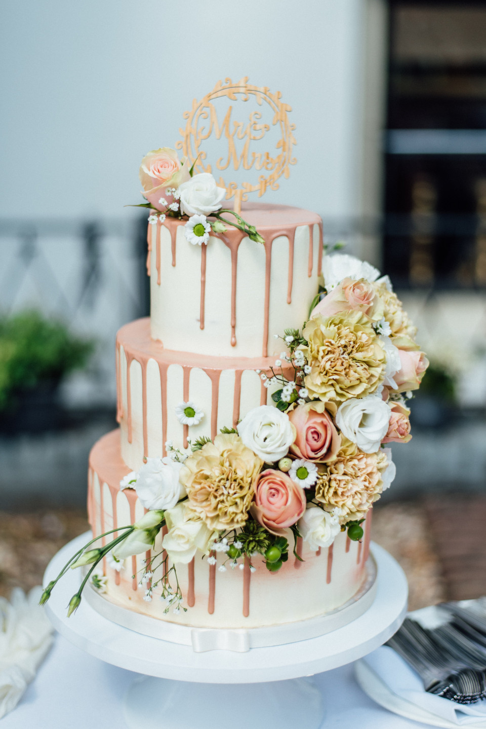 een bruidstaart met roze en witte bloemen