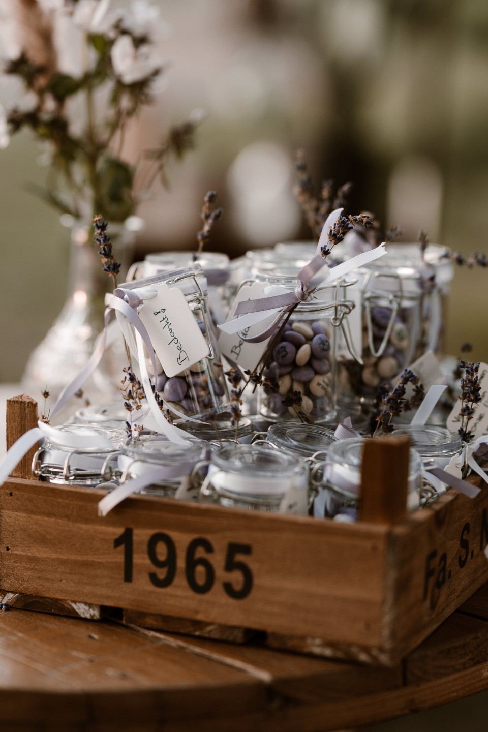 een houten krat gevuld met potten lavendelbloemen