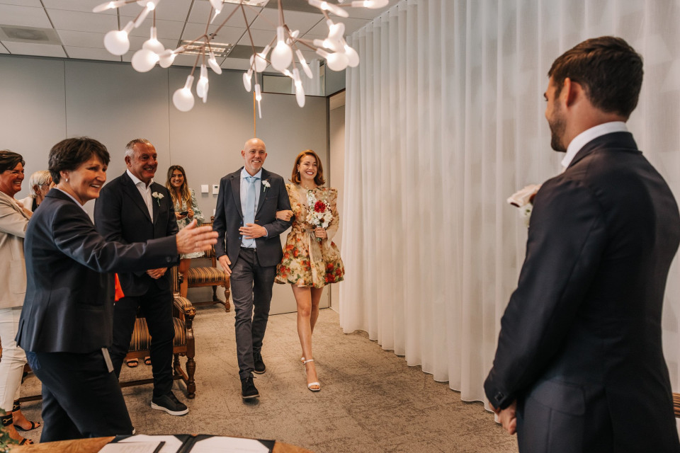 een man en vrouw lopen door het gangpad op een bruiloft