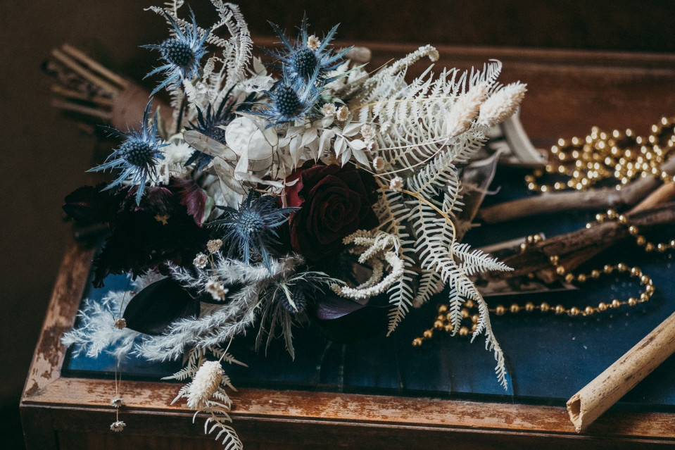 Getrocknete Blumen in dunklem Blau