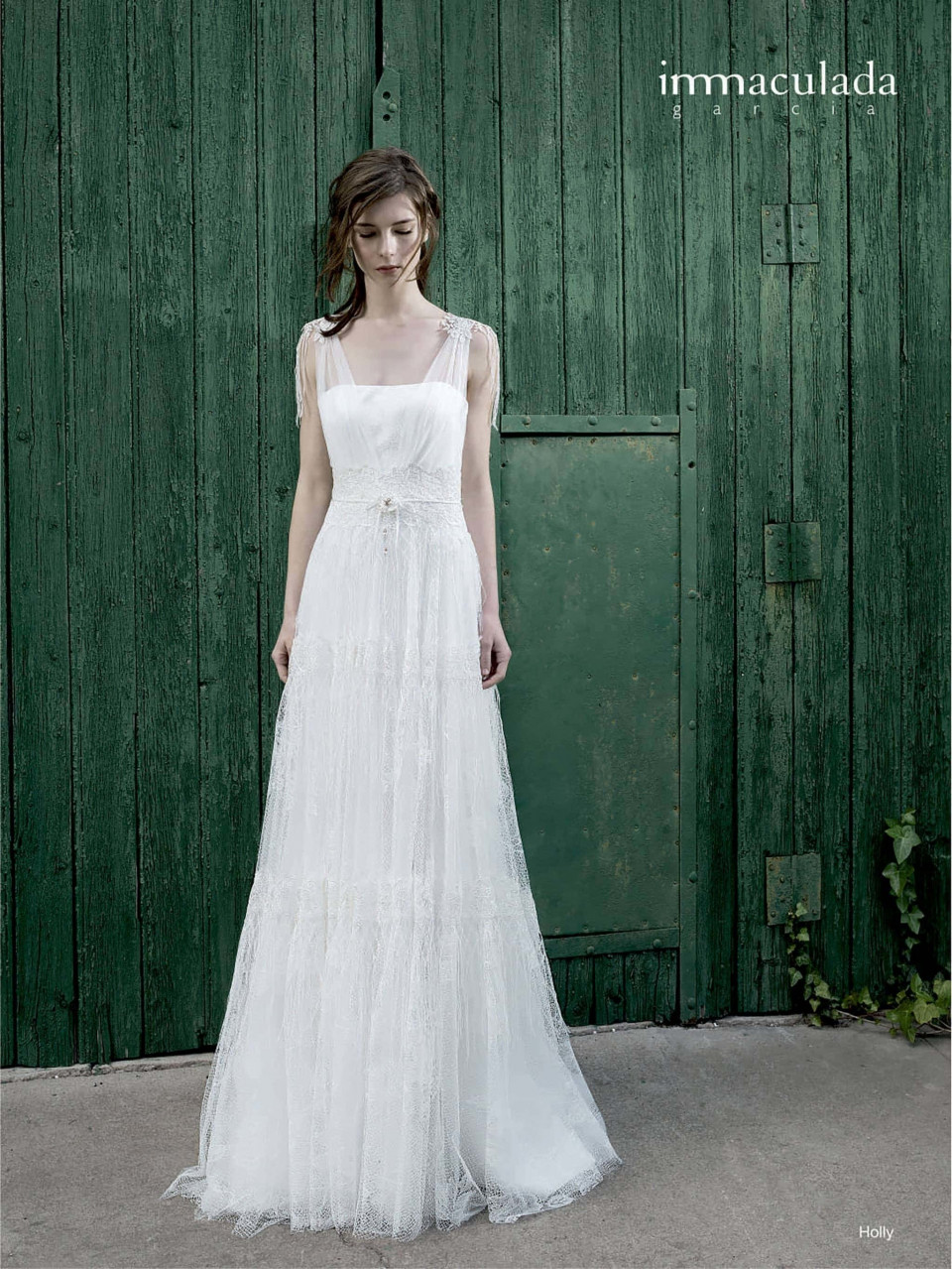 een vrouw in een witte trouwjurk die voor een groene deur staat