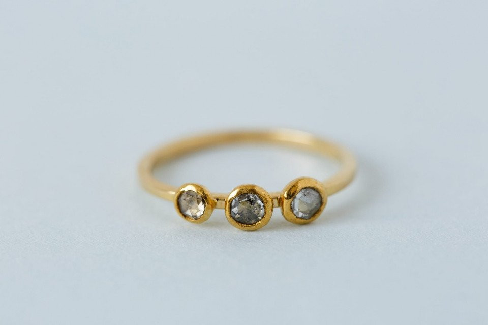 een gouden ring met drie diamanten erop
