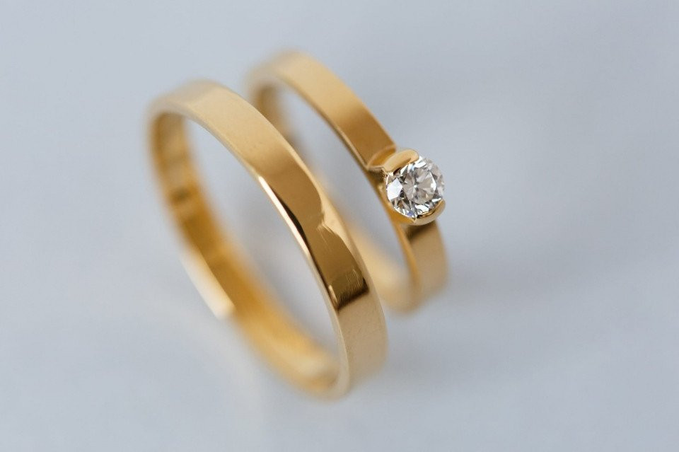 twee trouwringen met een diamant in het midden