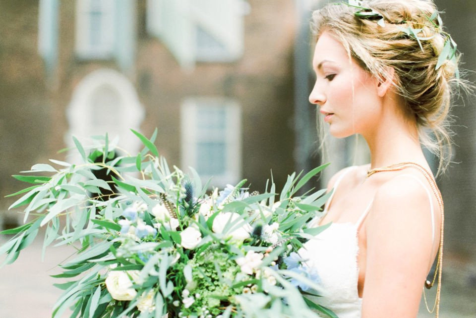 een mooie bruid die een boeket van groen vasthoudt