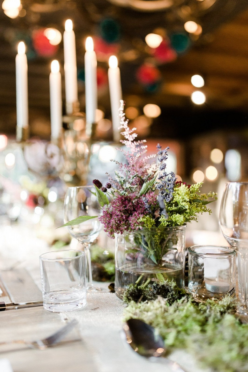 een tafel met kaarsen en bloemen erop