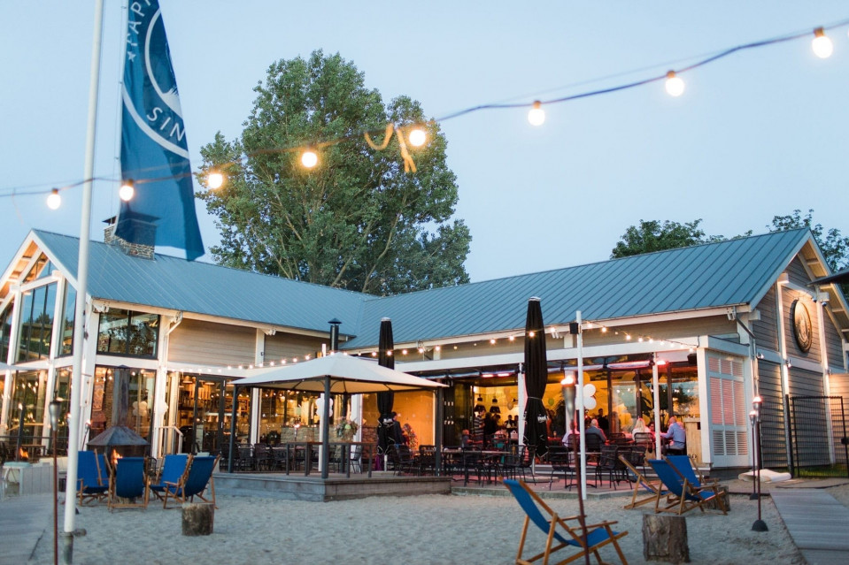 een restaurant met stoelen en tafels op het strand