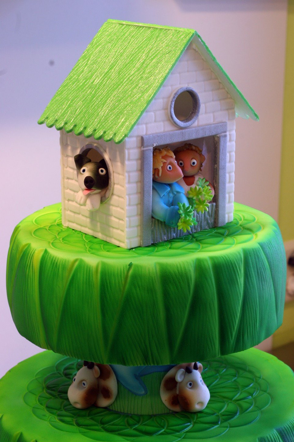 een taart met een huis er bovenop