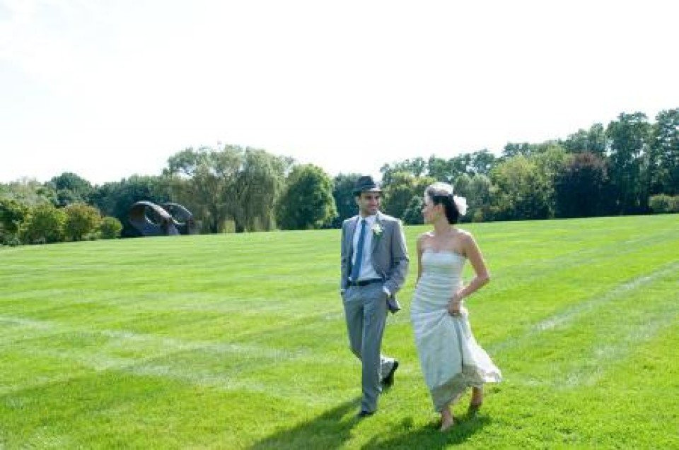 een bruid en bruidegom lopen door een veld