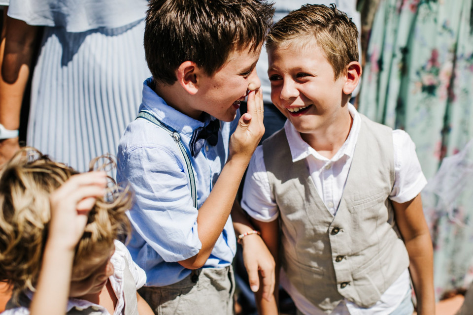 twee jongens lachen en een raakt zijn neus aan