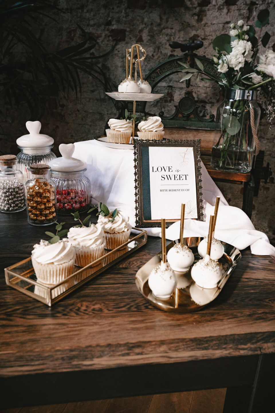 Sweet table with cake pops and cupcakes