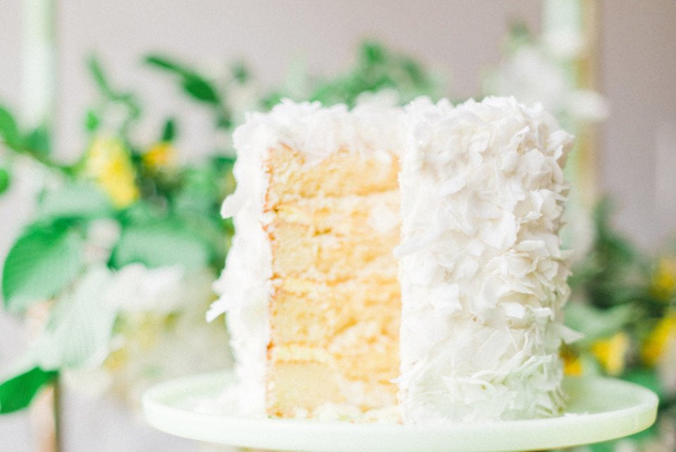 een plak witte taart op een groene taartstandaard